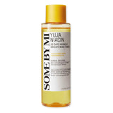 A 150 ml clear bottle of Yuja Niacin Brightening Toner with a yellow cap and a white label featuring black and gold text, enriched with Vitamin C.